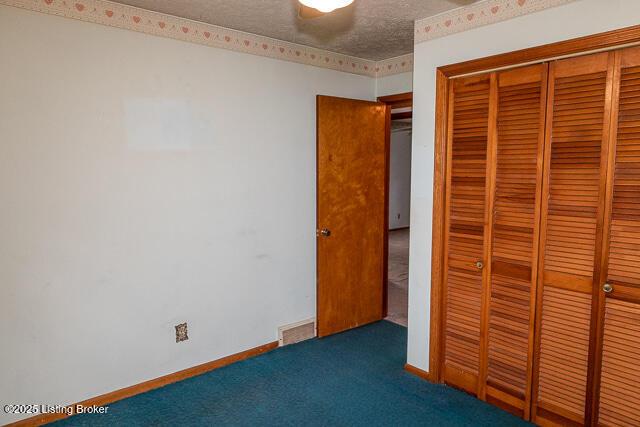 3110 Mount Lebanon Rd, Charlestown, IN 47111 - unfurnished bedroom featuring a closet, carpet floors, and a textured ceiling