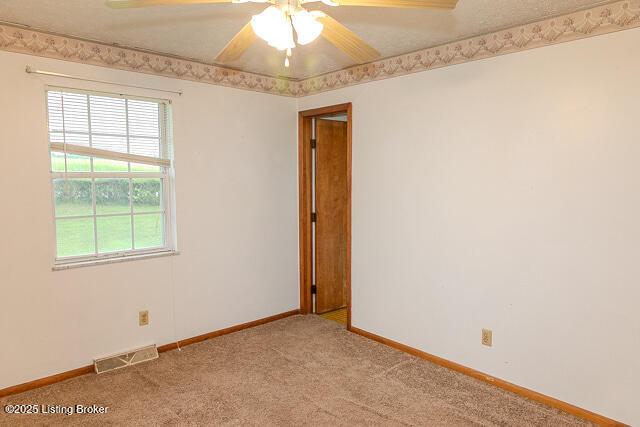3110 Mount Lebanon Rd, Charlestown, IN 47111 - empty room with light carpet, baseboards, and ceiling fan