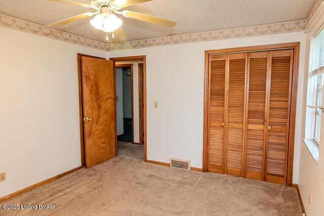 3110 Mount Lebanon Rd, Charlestown, IN 47111 - unfurnished bedroom with a closet, carpet, baseboards, and ceiling fan