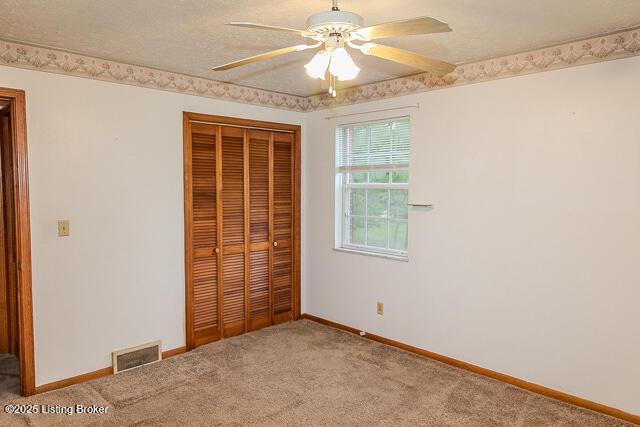 3110 Mount Lebanon Rd, Charlestown, IN 47111 - unfurnished bedroom with a closet, carpet, baseboards, and a ceiling fan