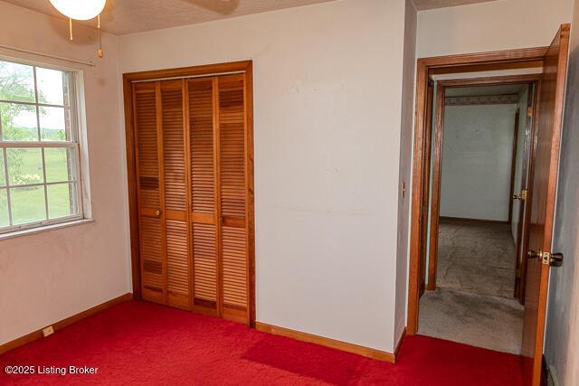 3110 Mount Lebanon Rd, Charlestown, IN 47111 - unfurnished bedroom featuring carpet floors, a closet, and baseboards