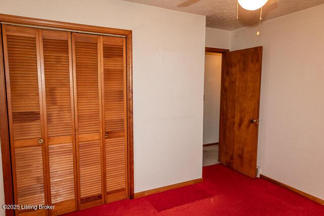 3110 Mount Lebanon Rd, Charlestown, IN 47111 - unfurnished bedroom with a closet, carpet floors, baseboards, and a textured ceiling