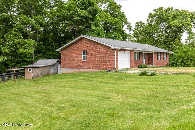 3110 Mount Lebanon Rd, Charlestown, IN 47111 - view of front facade with brick siding, a garage, and view of scattered trees