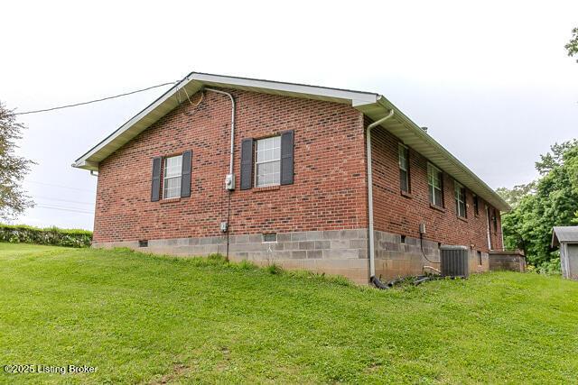 3110 Mount Lebanon Rd, Charlestown, IN 47111 - view of side of home with central AC, a yard, and brick siding