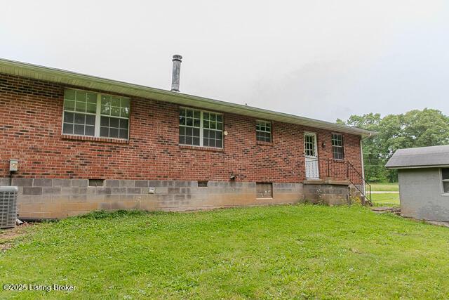 3110 Mount Lebanon Rd, Charlestown, IN 47111 - rear view of house featuring a yard, brick siding, and crawl space