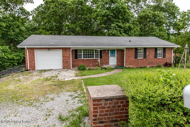 3110 Mount Lebanon Rd, Charlestown, IN 47111 - single story home featuring a garage, a front yard, driveway, view of wooded area, and brick siding