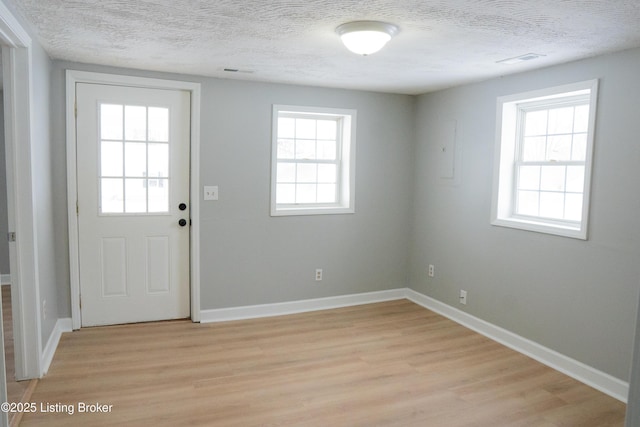 1206 W Walnut St, Danville, KY 40422 - doorway to outside featuring light wood finished floors and a textured ceiling