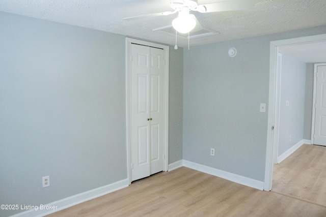 1206 W Walnut St, Danville, KY 40422 - unfurnished bedroom with light wood finished floors, a closet, a textured ceiling, and a ceiling fan