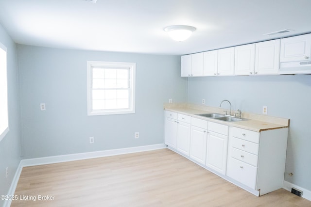 1206 W Walnut St, Danville, KY 40422 - kitchen with exhaust hood, light wood finished floors, white cabinets, and light countertops