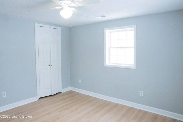 1206 W Walnut St, Danville, KY 40422 - unfurnished bedroom featuring light wood-style floors, a closet, a ceiling fan, and a textured ceiling