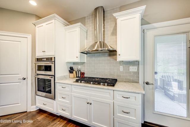 12406 Poplar Woods Dr, Goshen, KY 40026 - kitchen with wall chimney exhaust hood, stainless steel appliances, white cabinets, tasteful backsplash, and recessed lighting