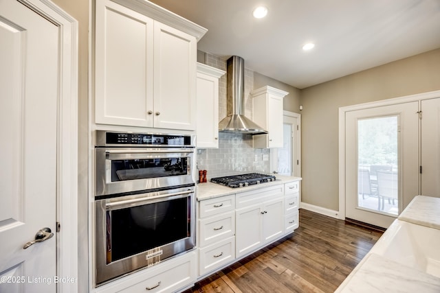 12406 Poplar Woods Dr, Goshen, KY 40026 - kitchen featuring stainless steel appliances, wall chimney exhaust hood, backsplash, white cabinetry, and dark wood-type flooring