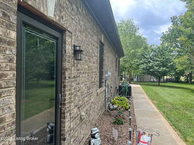 140 Ranch Ln, Loretto, KY 40037 - view of side of home featuring a lawn, brick siding, and central AC unit