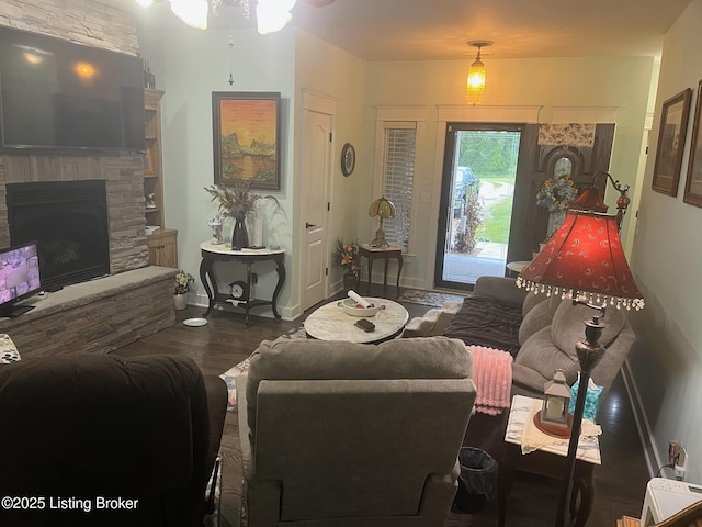 140 Ranch Ln, Loretto, KY 40037 - living area with wood finished floors, a stone fireplace, and baseboards