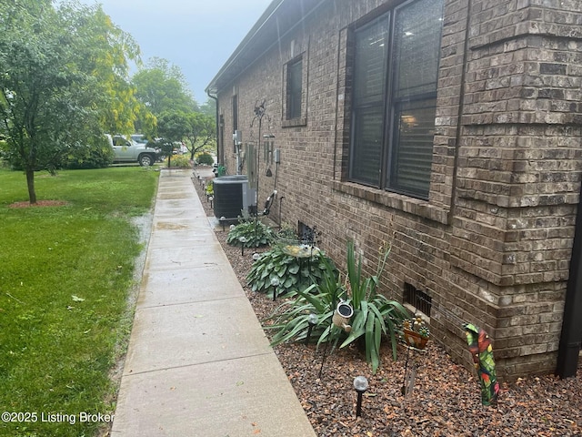 140 Ranch Ln, Loretto, KY 40037 - view of home's exterior featuring central AC, a yard, and brick siding