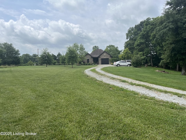140 Ranch Ln, Loretto, KY 40037 - view of grassy yard featuring driveway and an attached garage