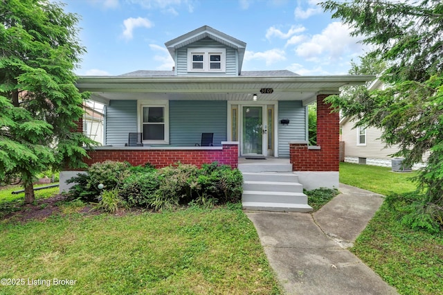 3707 Lentz Ave, Louisville, KY 40215 - view of front of home with brick siding, a porch, and a front yard