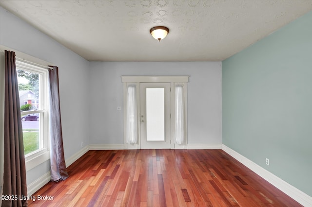 3707 Lentz Ave, Louisville, KY 40215 - foyer entrance with plenty of natural light, wood finished floors, baseboards, and a textured ceiling