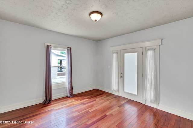 3707 Lentz Ave, Louisville, KY 40215 - empty room with light wood-style flooring, baseboards, and a textured ceiling