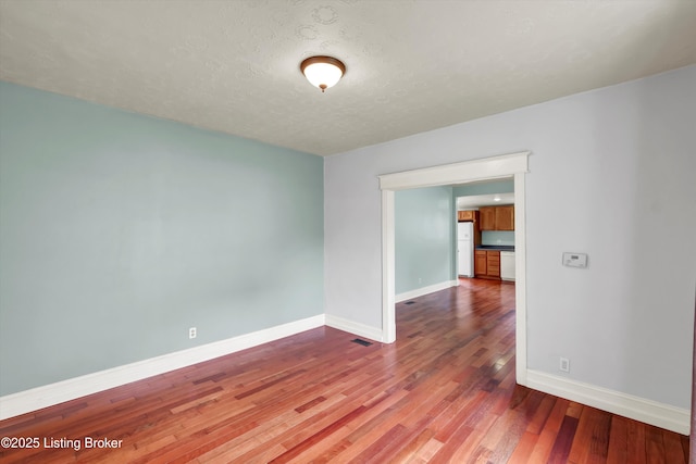 3707 Lentz Ave, Louisville, KY 40215 - unfurnished room featuring baseboards, wood finished floors, and a textured ceiling