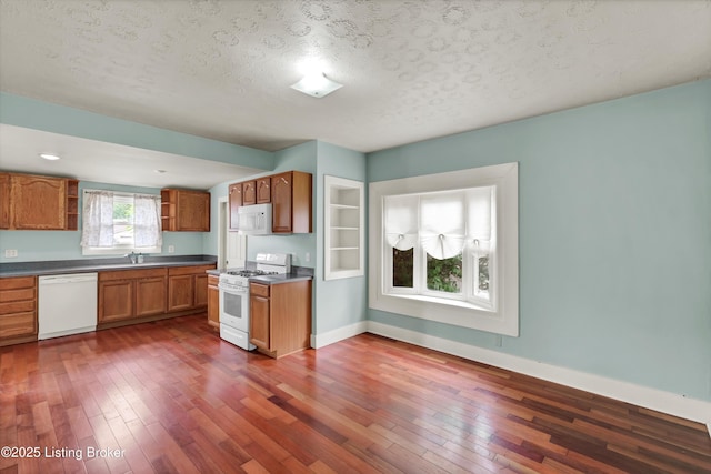 3707 Lentz Ave, Louisville, KY 40215 - kitchen featuring white appliances, open shelves, dark countertops, brown cabinets, and dark wood-type flooring