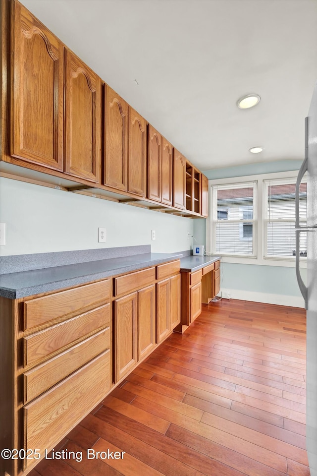 3707 Lentz Ave, Louisville, KY 40215 - kitchen with wood-type flooring, open shelves, recessed lighting, baseboards, and brown cabinetry
