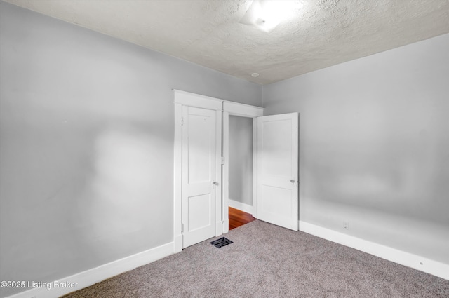 3707 Lentz Ave, Louisville, KY 40215 - unfurnished bedroom with carpet floors, a textured ceiling, and baseboards