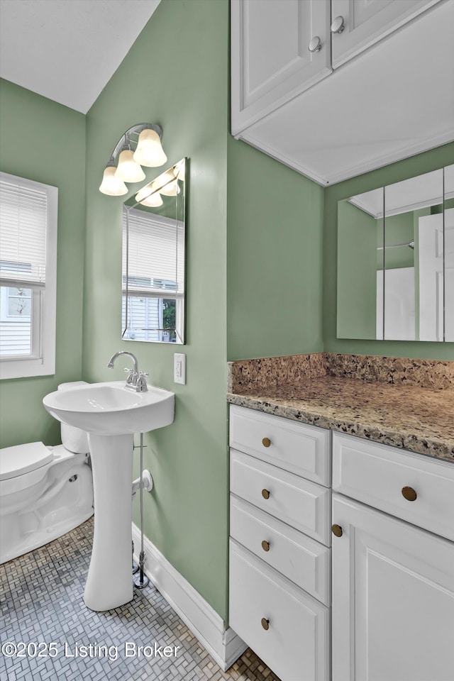 3707 Lentz Ave, Louisville, KY 40215 - bathroom featuring baseboards, toilet, and tile patterned floors