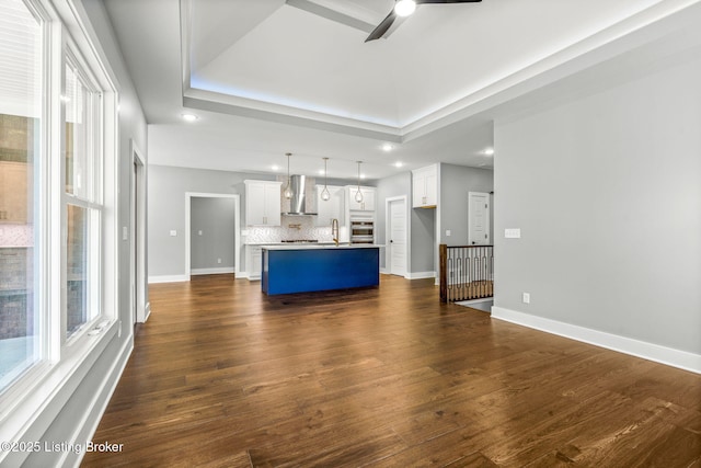 912 Artisan Pkwy, La Grange, KY 40031 - unfurnished living room with a ceiling fan, baseboards, a tray ceiling, dark wood-style flooring, and recessed lighting