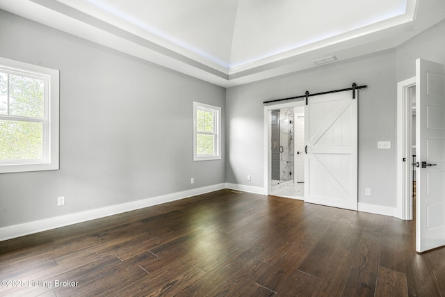 912 Artisan Pkwy, La Grange, KY 40031 - spare room featuring wood finished floors, a barn door, and baseboards