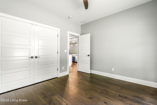 912 Artisan Pkwy, La Grange, KY 40031 - unfurnished bedroom featuring dark wood-style flooring, baseboards, a closet, and ceiling fan