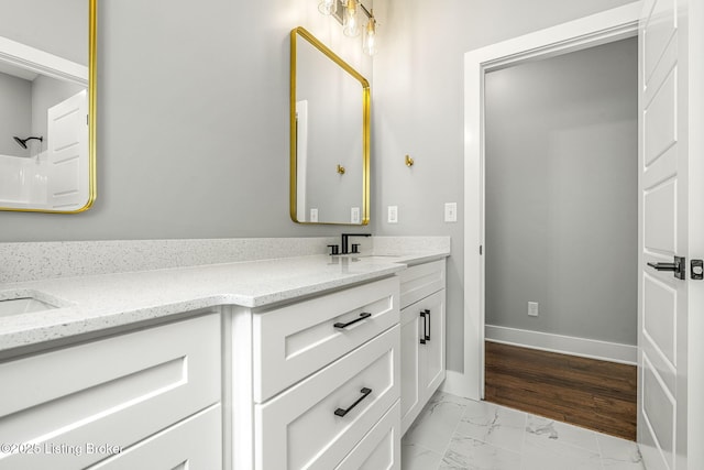 912 Artisan Pkwy, La Grange, KY 40031 - bathroom with double vanity, marble look tiles, and baseboards