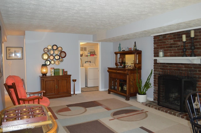 7506 Greenlawn Rd, Louisville, KY 40242 - living area with washing machine and clothes dryer, a textured ceiling, and a fireplace