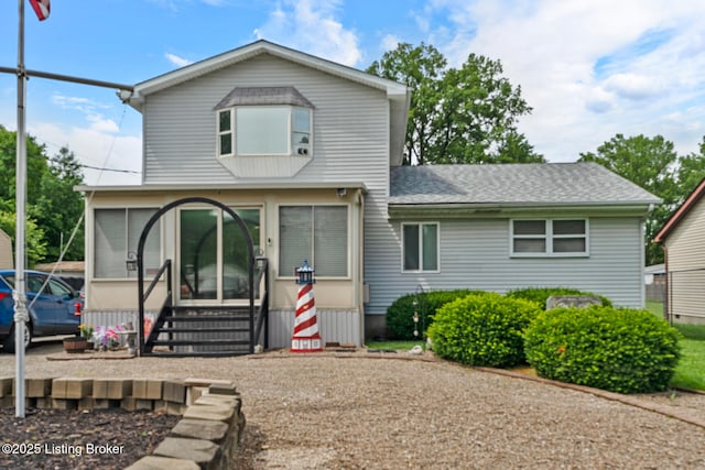 1261 Lipps Ln, Louisville, KY 40219 - view of front of property with entry steps, a sunroom, and roof with shingles
