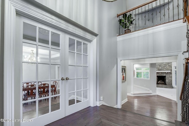 603 Woodlake Dr, Louisville, KY 40245 - interior space featuring dark wood-style flooring, baseboards, a stone fireplace, a chandelier, and a towering ceiling