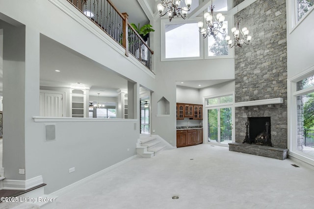 603 Woodlake Dr, Louisville, KY 40245 - unfurnished living room featuring a chandelier, a high ceiling, a fireplace, carpet floors, and baseboards