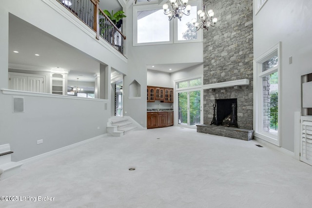 603 Woodlake Dr, Louisville, KY 40245 - unfurnished living room with a high ceiling, a chandelier, carpet, and a stone fireplace