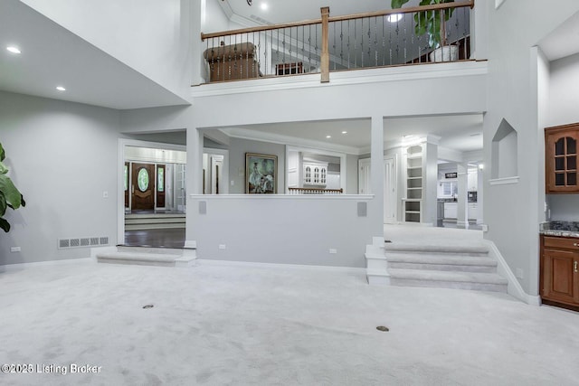 603 Woodlake Dr, Louisville, KY 40245 - unfurnished living room with a towering ceiling, carpet flooring, baseboards, recessed lighting, and ornate columns