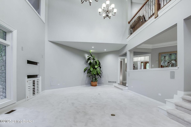603 Woodlake Dr, Louisville, KY 40245 - carpeted foyer entrance featuring a towering ceiling, a chandelier, baseboards, and stairway