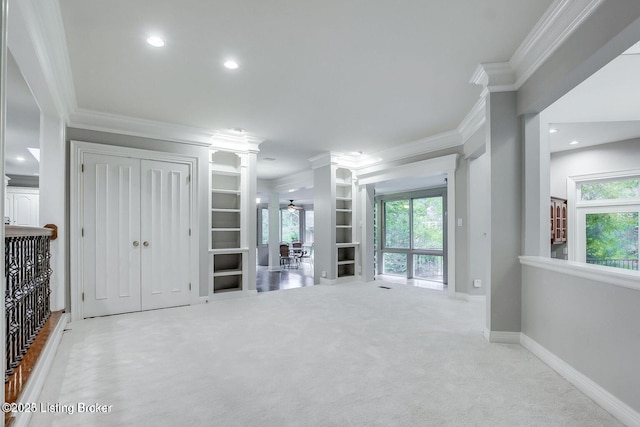 603 Woodlake Dr, Louisville, KY 40245 - unfurnished living room featuring ornamental molding, carpet floors, ornate columns, plenty of natural light, and baseboards
