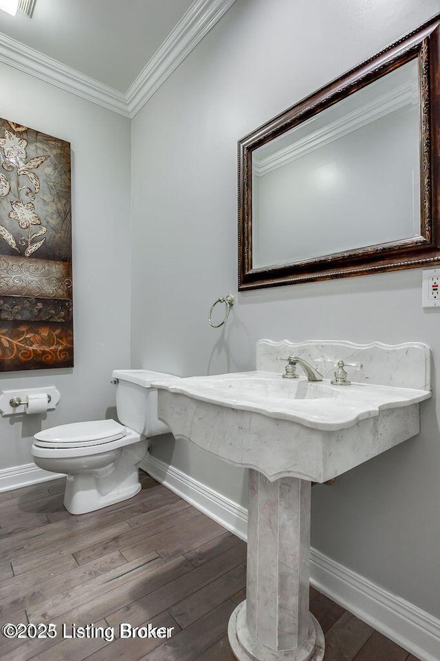 603 Woodlake Dr, Louisville, KY 40245 - bathroom with baseboards, toilet, wood finished floors, and ornamental molding