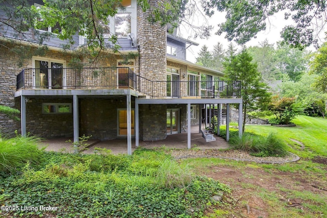 603 Woodlake Dr, Louisville, KY 40245 - rear view of house featuring a patio area, stone siding, a deck, and a yard