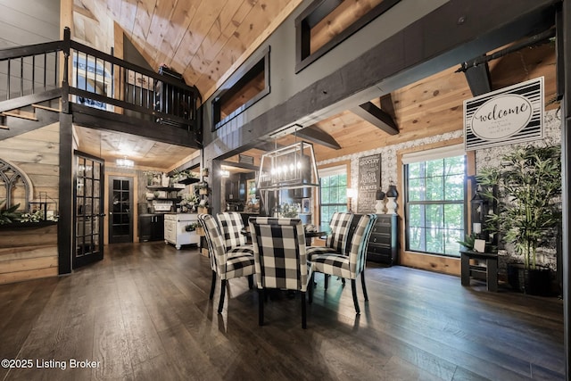 282 Lakeview Ln, Mcdaniels, KY 40152 - dining area with hardwood / wood-style floors, a high ceiling, stairs, and wood walls