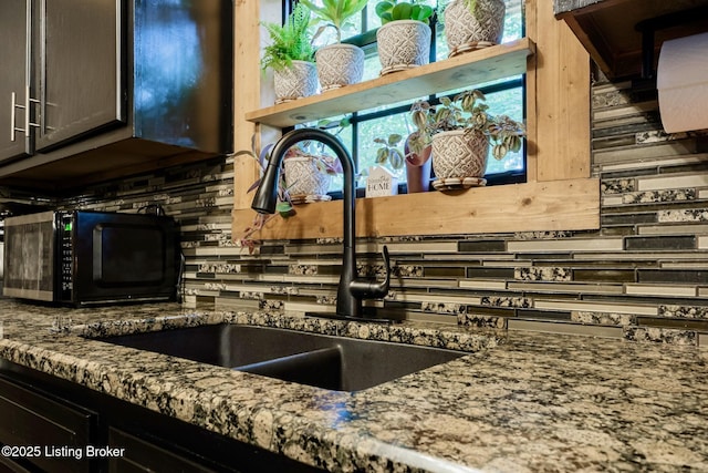 282 Lakeview Ln, Mcdaniels, KY 40152 - kitchen with black microwave, tasteful backsplash, stone counters, and a sink