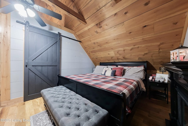 282 Lakeview Ln, Mcdaniels, KY 40152 - bedroom with wooden ceiling, wood finished floors, wood walls, and a barn door