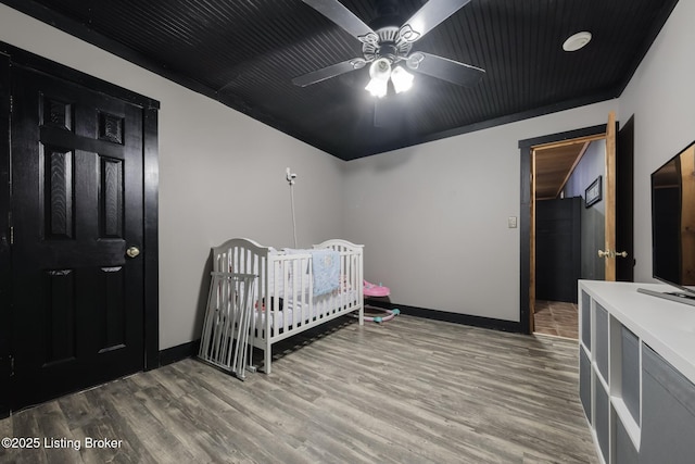 282 Lakeview Ln, Mcdaniels, KY 40152 - bedroom featuring wood finished floors, baseboards, a nursery area, and a ceiling fan