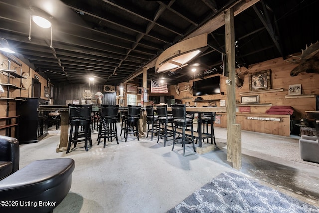 282 Lakeview Ln, Mcdaniels, KY 40152 - dining space featuring a dry bar, wooden walls, and concrete flooring