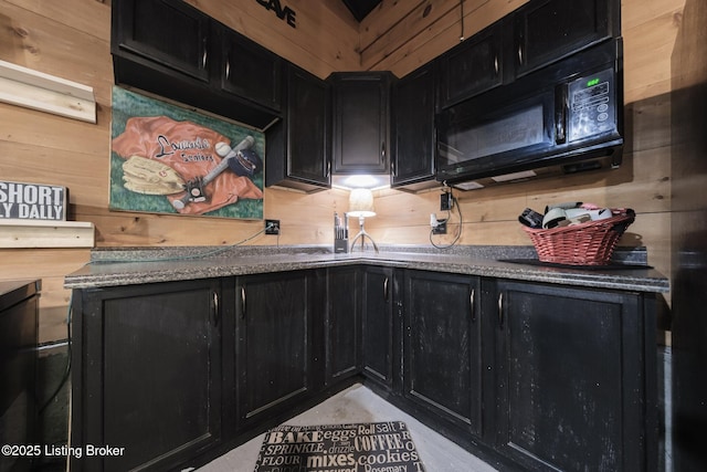 282 Lakeview Ln, Mcdaniels, KY 40152 - kitchen featuring dark cabinets, black microwave, and wooden walls