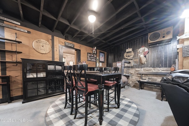 282 Lakeview Ln, Mcdaniels, KY 40152 - dining room featuring unfinished concrete floors and wooden walls