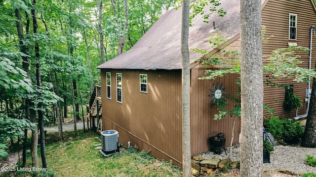 282 Lakeview Ln, Mcdaniels, KY 40152 - view of side of property with central AC, roof with shingles, and stairway